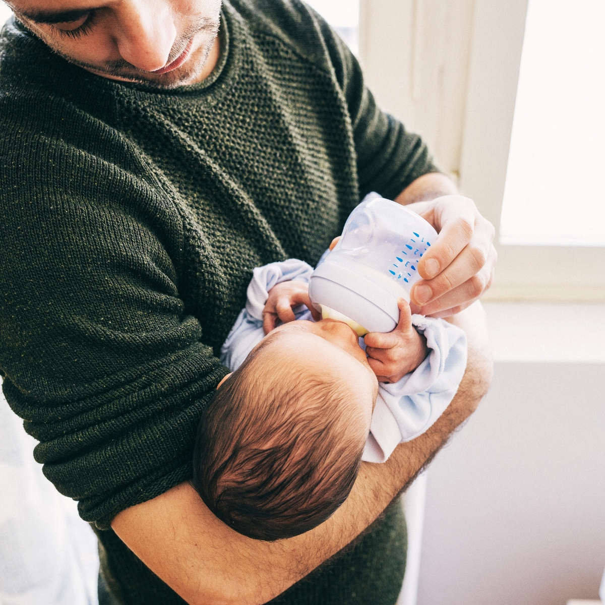 Mother and baby experiencing a comfortable, pain-free breastfeeding latch after lactation support